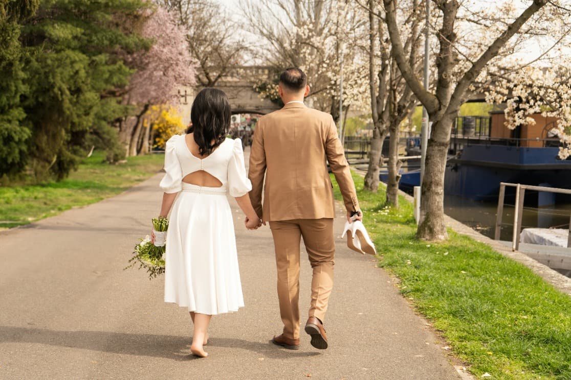 Couple walking on a path by the water